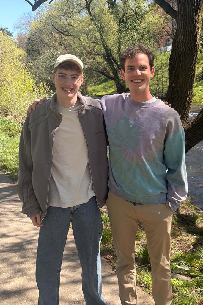 Two friends in a park by a river – capturing memories and writing to your future self with Capsy